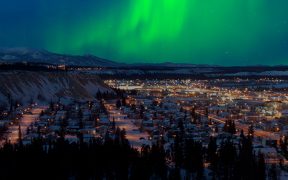 Image of the Yukon at night with Northern Lights in the distance for Building Familiarity with Federal Foresight Approaches and Tools in the Yukon blog post