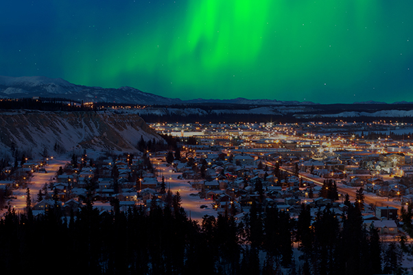 Image of the Yukon at night with Northern Lights in the distance for Building Familiarity with Federal Foresight Approaches and Tools in the Yukon blog post