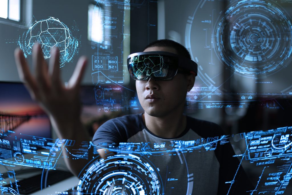 Image of man wearing mixed reality headset and interacting with virtual objects